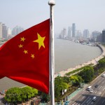 Chinese flag overlooking cityscape, Shanghai, China