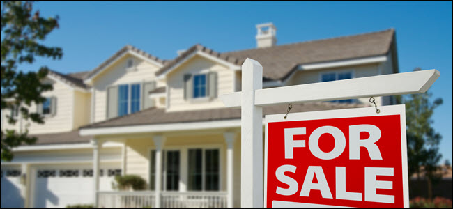 Home For Sale Real Estate Sign in Front of New House.