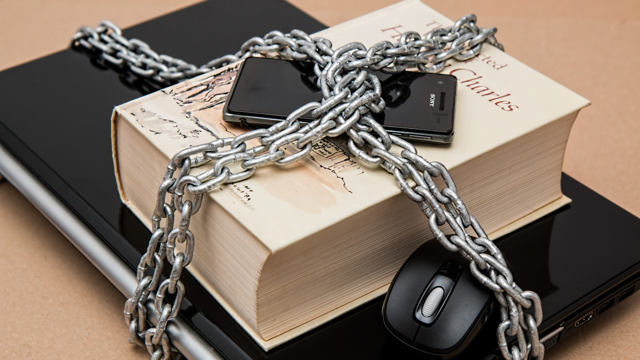 Book and phone wrapped in chains