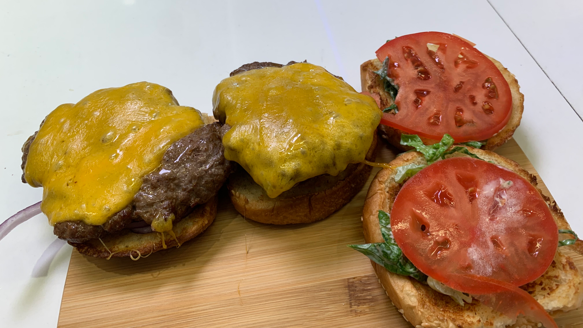 burgers on cutting board